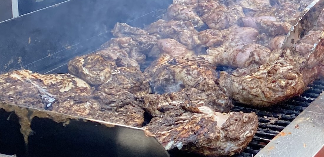 Authentic Jamaican jerk chicken sizzling on the grill